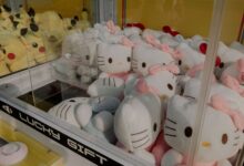 Claw machine featuring plush Hello Kitty and Pikachu toys, ideal for arcade entertainment.