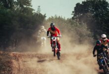 Action-packed motocross race with riders speeding through a dusty track, showcasing excitement and competition.