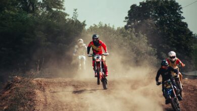 Action-packed motocross race with riders speeding through a dusty track, showcasing excitement and competition.