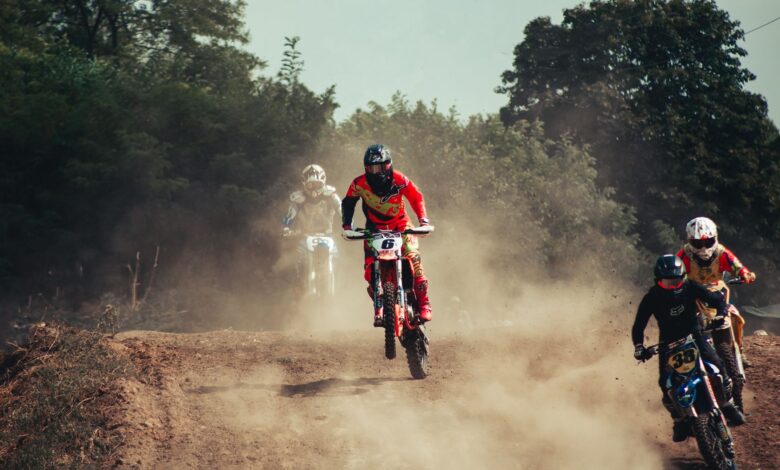 Action-packed motocross race with riders speeding through a dusty track, showcasing excitement and competition.