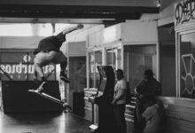 High-flying skateboard trick captured indoors in striking black and white.