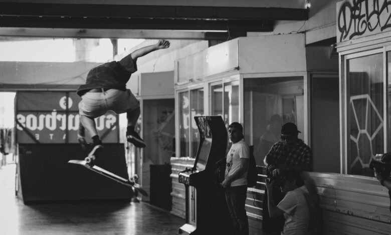 High-flying skateboard trick captured indoors in striking black and white.