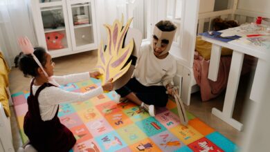 Joyful siblings have fun playing pretend knights in handmade costumes indoors.