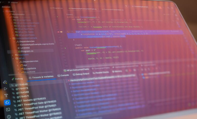 Focused view of a computer screen displaying programming code with visible reflections.