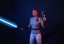 A woman dressed in sci-fi costume wields a lightsaber and blaster in a dramatic studio setting.