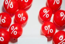 Red balloons with percentage signs, ideal for marketing promotions and sales events.
