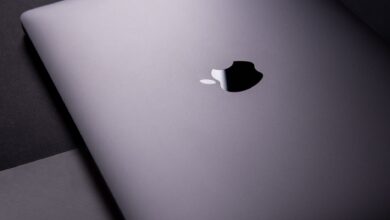Close-up of a sleek, modern laptop featuring a minimalist design on a dark surface.