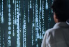 An individual viewing glowing numbers on a screen, symbolizing technology and data.