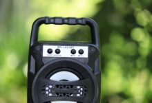 Close-up of portable Bluetooth speaker MS-1615BT in a vibrant outdoor setting.