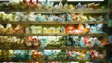 Vibrant collection of assorted plush toys packaged neatly on store shelves.