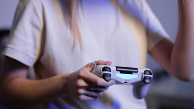Person playing video games with game controller in a relaxed setting.