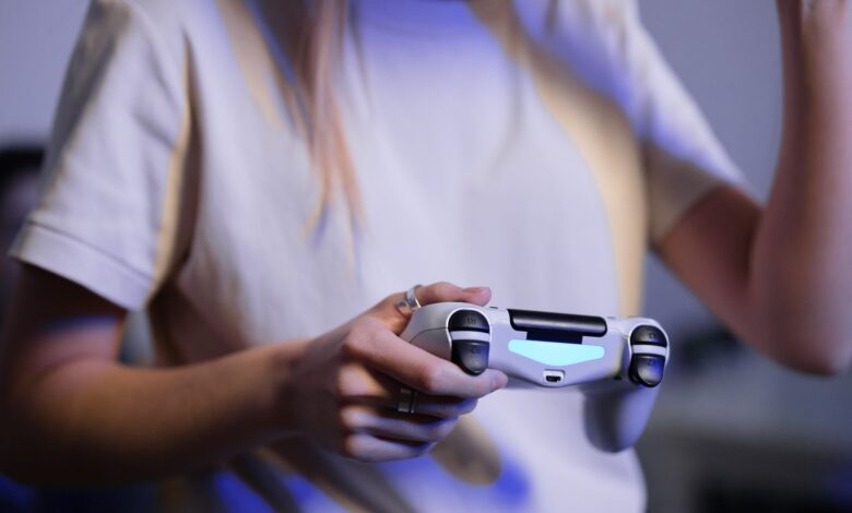 Person playing video games with game controller in a relaxed setting.