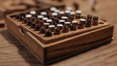 Detailed view of a wooden board game with black and white pieces, symbolizing strategy and leisure.