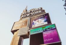 Iconic New York New York casino sign on the Las Vegas Strip showcasing Cirque du Soleil promotion.