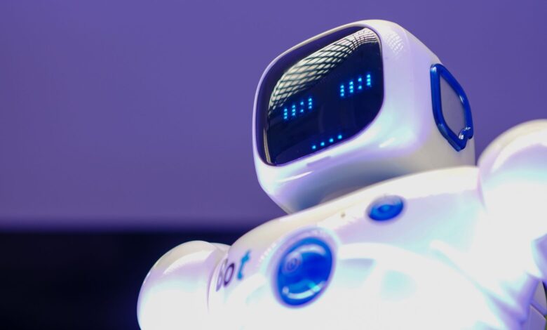 A modern humanoid robot with digital face and luminescent screen, symbolizing innovation in technology.