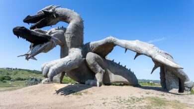 Impressive dragon sculpture outdoors on a sunny day, offering a captivating view.