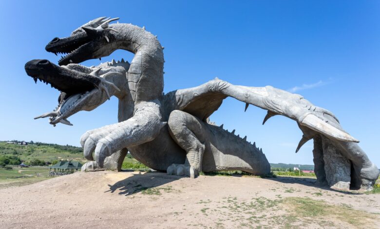 Impressive dragon sculpture outdoors on a sunny day, offering a captivating view.