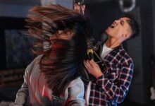 Two friends enjoying an intense Guitar Hero session, feeling the music.
