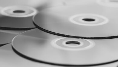 Monochrome close-up view of stacked optical discs. Minimalist design in grayscale.
