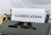 Close-up of a vintage typewriter displaying the word 'Gamification' on paper.
