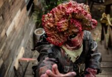 A detailed zombie cosplay costume depicting horror elements in an outdoor setting.