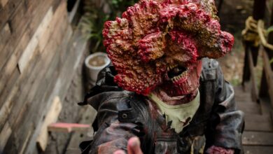 A detailed zombie cosplay costume depicting horror elements in an outdoor setting.