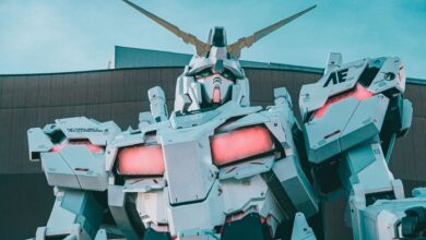 Striking view of a giant robot sculpture with vibrant LED accents in an urban setting.