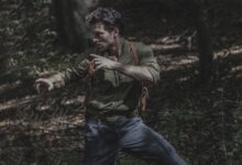 A man engages in martial arts practice amidst a dense forest environment, showcasing survival skills.