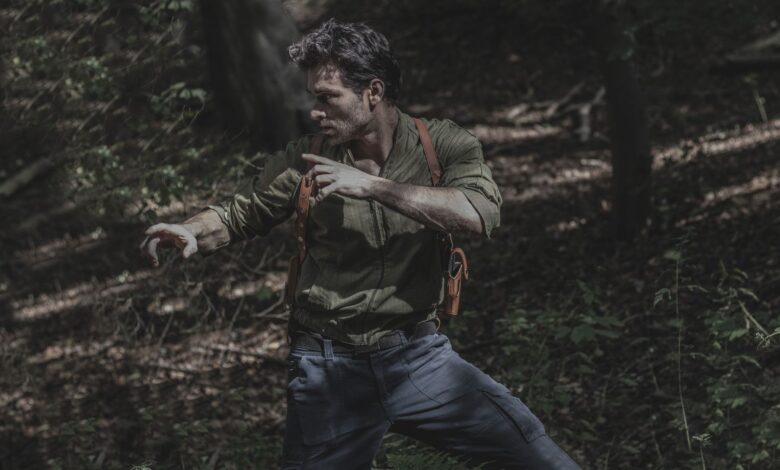 A man engages in martial arts practice amidst a dense forest environment, showcasing survival skills.