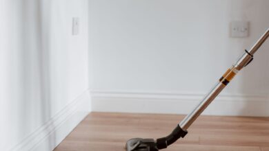 Electrical apparatus collecting dust on wooden parquet in empty room of apartment in daylight
