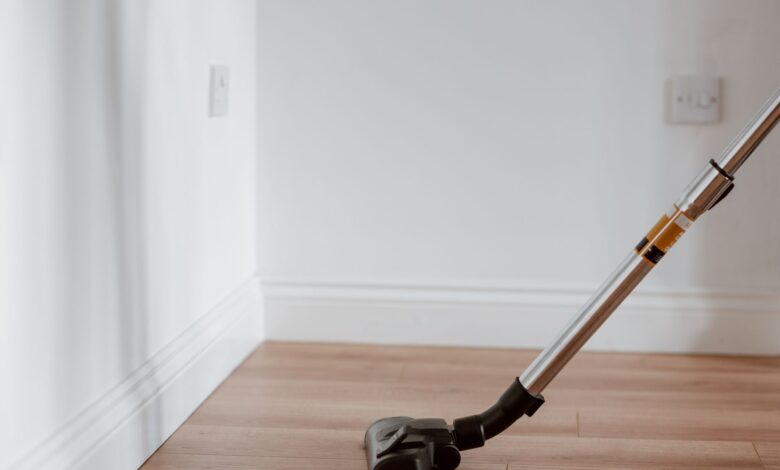 Electrical apparatus collecting dust on wooden parquet in empty room of apartment in daylight