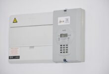 Electrical meter and fuse box on a white wall in Cape Town, South Africa, for energy monitoring or billing.