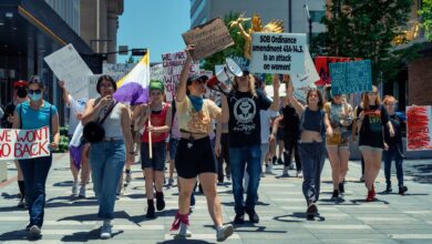 Women leading a vibrant protest for empowerment and social justice in an urban setting.