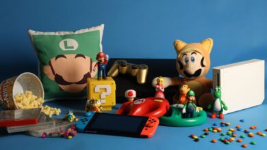 A vibrant assortment of gaming collectibles, including Nintendo figures, consoles, and candy on a blue background.