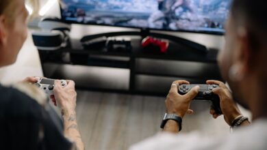 Two friends enjoying a video game session indoors using controllers, focusing on teamwork and fun.