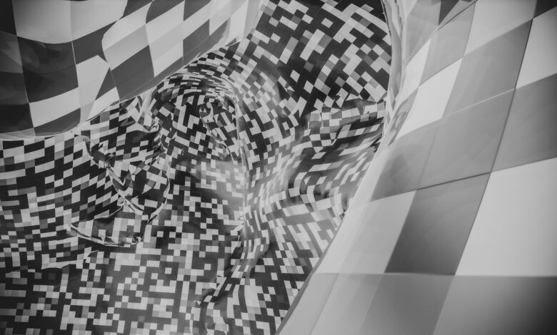 Abstract image featuring a black and white checkered pattern with pixelated forms.