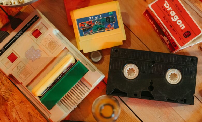 Vintage gaming console with cartridges and VHS tape on wooden surface, nostalgic theme.