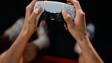 Hands gripping a modern game controller, ready for immersive gaming experience.
