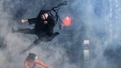 Two cosplayers enact a thrilling martial arts battle immersed in foggy atmosphere.