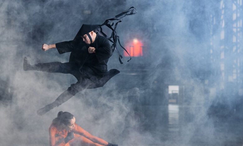 Two cosplayers enact a thrilling martial arts battle immersed in foggy atmosphere.