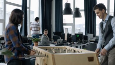 A modern office environment featuring a foosball table with employees engaging in teamwork.