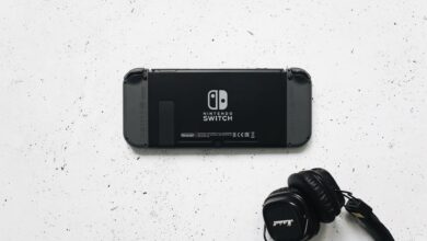 Nintendo Switch and headphones on a minimalist marble background, perfect for gaming content.
