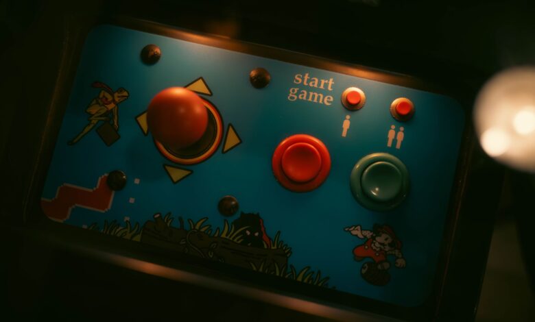 Close-up of retro arcade game controls with joystick and buttons