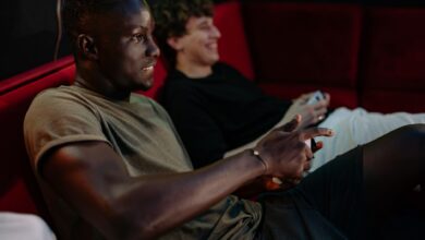 Two friends enjoying a video game session together indoors with controllers.