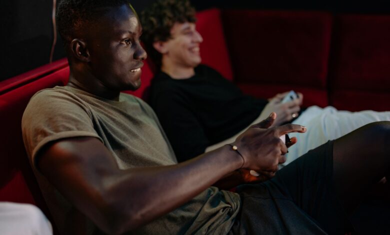 Two friends enjoying a video game session together indoors with controllers.