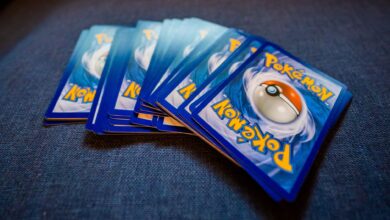 From above of pack of collectible cards with images of fantastic creatures on backs located on gray backdrop
