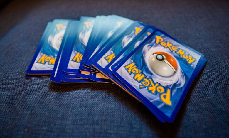 From above of pack of collectible cards with images of fantastic creatures on backs located on gray backdrop