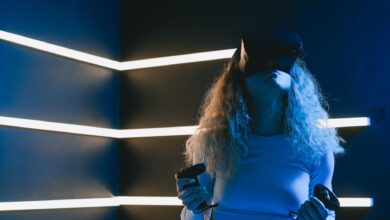 Woman using virtual reality headset with controllers in a modern setting.