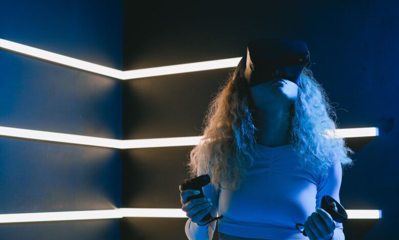 Woman using virtual reality headset with controllers in a modern setting.