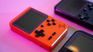 Vibrant and nostalgic handheld gaming console in focus, showcasing retro design with a pop of color.